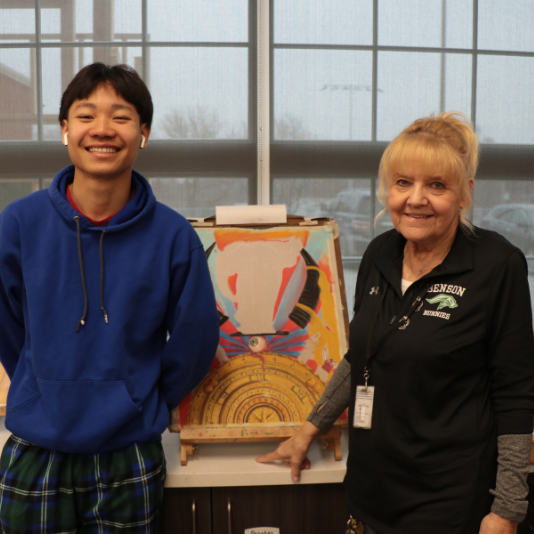  Astra Patterson poses with a student and their artwork